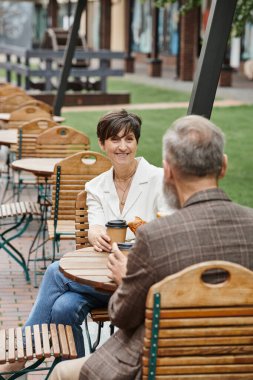 cheerful woman and man, drinking coffee in outdoor cafe, terrace, elderly couple, summer, urban clipart