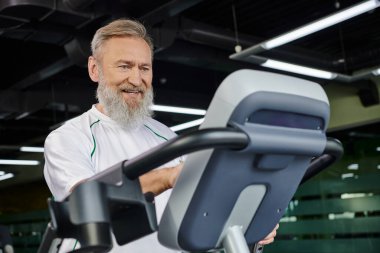 happy and bearded man exercising on treadmill, cardio, sport, elderly work out, active senior clipart