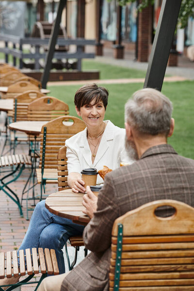 cheerful woman and man, drinking coffee in outdoor cafe, terrace, elderly couple, summer, urban