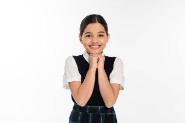 cheerful schoolgirl in black vest looking at camera isolated on white, school uniform, excitement clipart