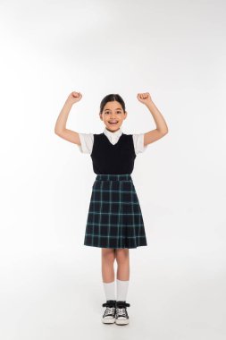 excitement, happy schoolgirl celebrating back to school, isolated on white, full length, uniform clipart