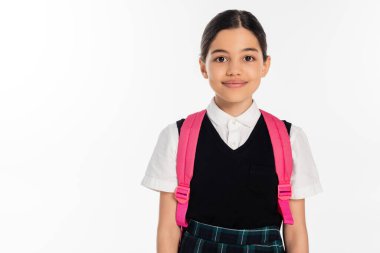 happy schoolgirl with pink backpack and black vest looking at camera isolated on white, student clipart
