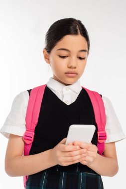 digital age, schoolgirl with backpack using smartphone isolated on white, student in uniform clipart