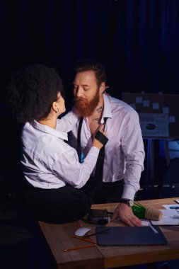Seksi Afrikalı Amerikalı kadın, iş yerindeki dağınıklığın yanında sakallı ve dövmeli meslektaşını baştan çıkarıyor.