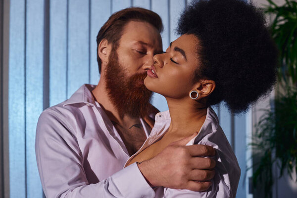 sensual african american woman with closed eyes near businessman undressing her in office, seduction