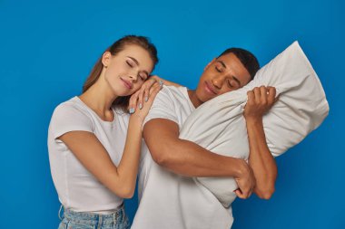 pleased interracial couple sleeping together on pillow, african american man and caucasian woman clipart
