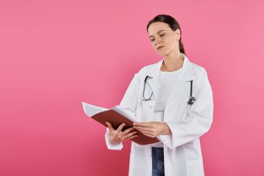 breast cancer awareness, female doctor, oncologist reading medical record, folder, pink backdrop clipart