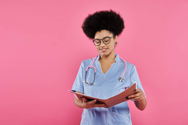 breast cancer awareness, african american doctor, happy oncologist reading medical record, folder