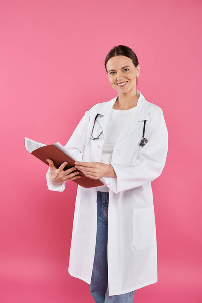 breast cancer awareness, female doctor, happy oncologist reading medical record, folder, pink