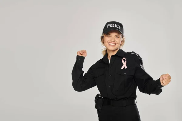 Excited Policewoman Pink Ribbon Breast Cancer Showing Yes Gesture Isolated — Stock Photo, Image