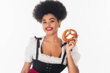 young african american waitress in traditional bavarian costume holding delicious pretzel on white clipart