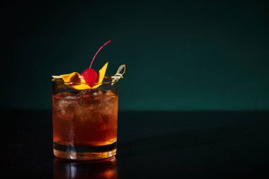 thirst quenching esthetic negroni with cherry full of ice on black backdrop, concept clipart