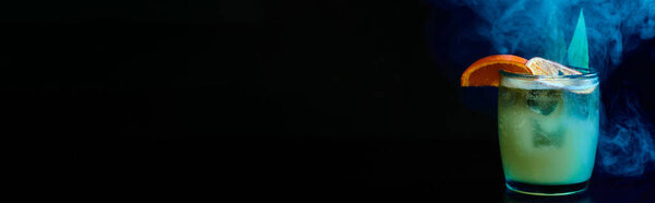 zesty old fashioned cocktail with orange slice on black smokey backdrop, concept, banner