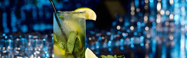 stock image esthetic mojito cocktail with mint leaves and lime on bar backdrop, concept, banner