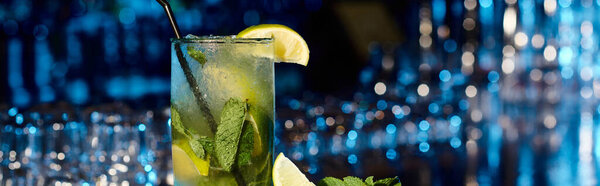 esthetic mojito cocktail with mint leaves and lime on bar backdrop, concept, banner
