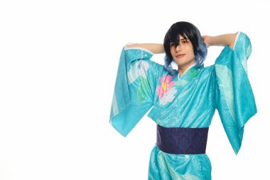 Mavi kimonolu genç adam, elleri başının arkasında kameraya bakıyor beyaz, rüya gibi Cosplayer 'a.