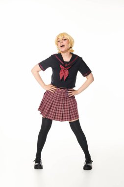 cosplay concept, woman in yellow blonde wig and school uniform posing with hands on hips on white clipart