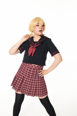 surprised anime woman in school uniform and yellow blonde wig standing with hand on hip on white clipart