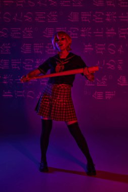 Okul üniformalı genç anime kadın elinde beyzbol sopasıyla neon mor zemin üzerinde hiyeroglifler var.