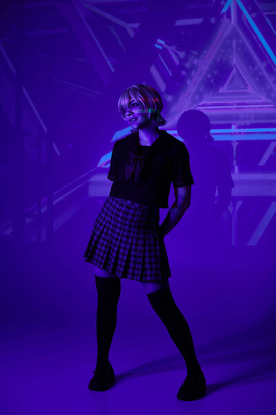 full length of woman in school uniform in blue neon light on abstract backdrop, anime concept