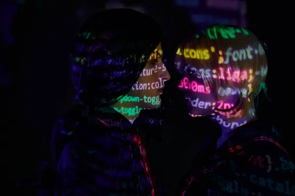 stock image side view of young couple with neon programming lettering on dark backdrop, anime style concept