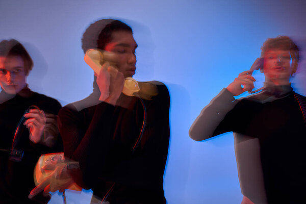three good looking young multicultural men with landline phones posing together, dynamic photo