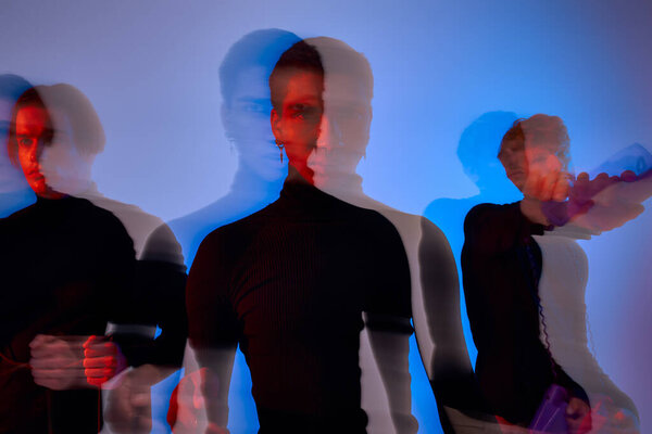 three handsome man in black casual attire posing in motion on gray backdrop, motion blur
