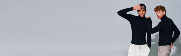 handsome diverse male models posing on gray backdrop, hand near face, hand on shoulder, banner