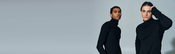 classy multicultural male models posing in black turtlenecks and looking at camera, banner