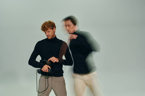 long exposure photo of two young men in elegant turtlenecks posing with retro phone, fashion concept