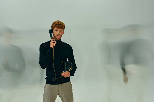 long blurred exposure photo of young man with retro phone surrounded by other male models, men power