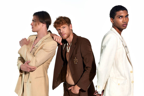 appealing elegant male models in unbuttoned suits with accessories posing actively, men power