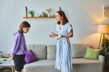 displeased woman gesturing and quarreling with upset teenage daughter at home, family issues clipart