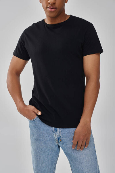 stylish african american male model posing in black t-shirt and jeans, copy space for advertising