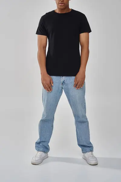 stock image stylish african american male model posing in black t-shirt and jeans, copy space for advertising