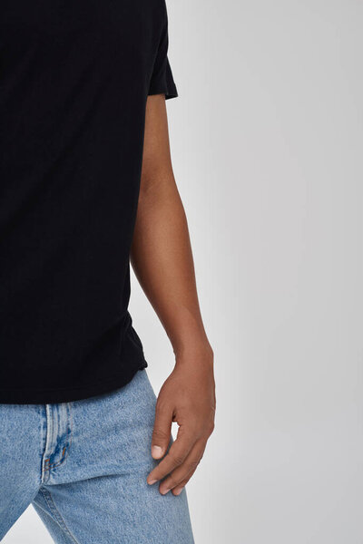 stylish african american male model posing in black t-shirt and jeans, copy space for advertising