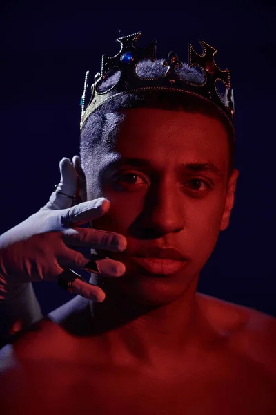 stock image female hand in white glove with rings near face of shirtless african american man with crown