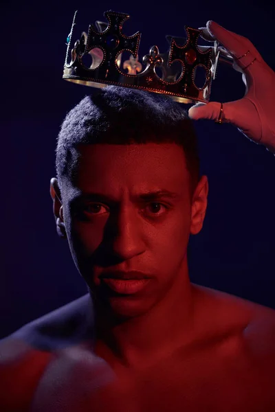 stock image female hand in white glove with rings near face of shirtless african american man with crown