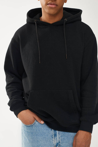 trendy african american male model in casual black hoodie and jeans, copy space for advertising