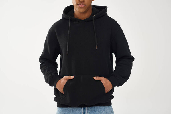 trendy african american male model in casual black hoodie and jeans, copy space for advertising