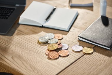 golden and silver bitcoins near notebooks on work desk in modern office, virtual cryptocurrency clipart