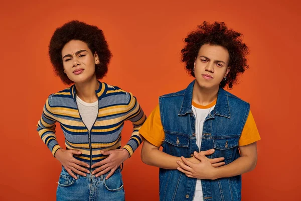 stock image sick african american brother and sister in everyday clothes feeling ill and looking at camera