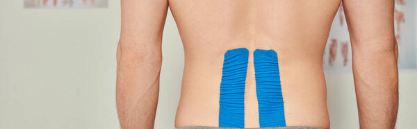 cropped view of man with kinesiological tapes on his back during appointment, healthcare, banner