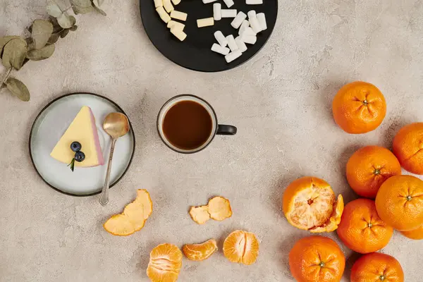 stock image Christmas background, hot chocolate and marshmallows near pudding and tangerines on grey surface