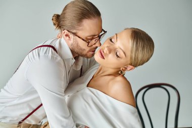 handsome young man with beard kissing his alluring sexy secretary while at office, work affair clipart