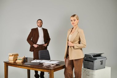 pensive beautiful woman with collected blonde hair posing next to her bearded boyfriend, work affair clipart