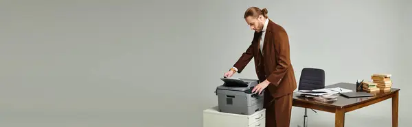 stock image handsome man with beard and collected hair in elegant jacket working with copy machine, banner