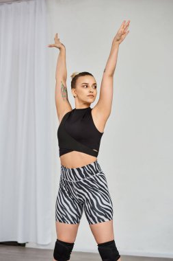A graceful woman in a striking outfit performs a dynamic choreography, while raising her hands clipart