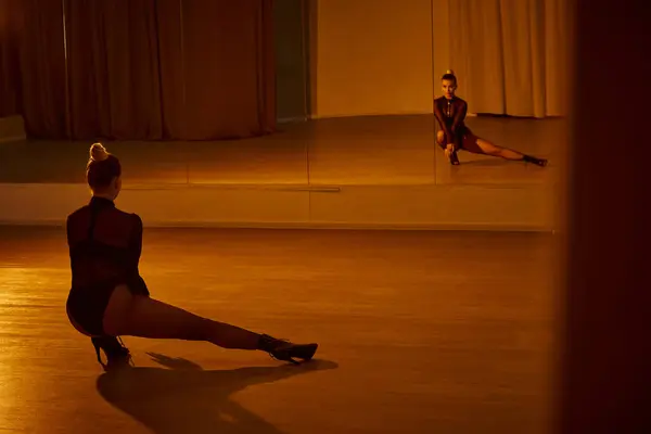 graceful woman with leg extended aside as she moves with fluidity and posing on high heels