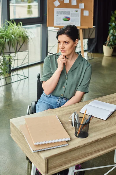 Attractive Businesswoman Comfy Attire Wheelchair Working Her Notebook Looking Away — Stock Photo, Image